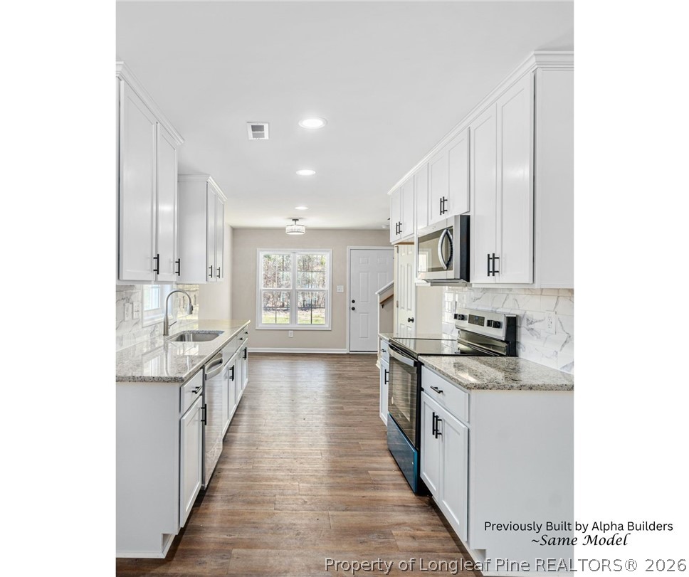 973 Martin Road St. Pauls, NC 28384 - Photo 2 of 19 Bright and open kitchen featuring granite countertops and soft-close cabinetry.