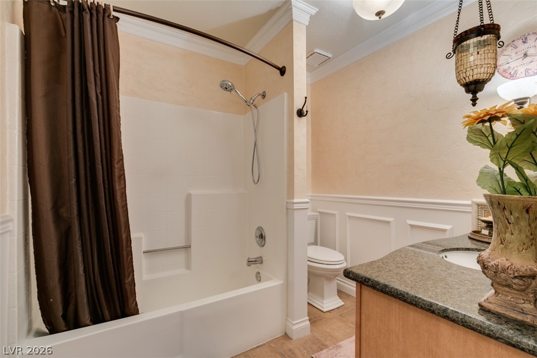 9325 West Desert Inn Road, Unit 244 Las Vegas, NV 89117 - Photo 29 of 55 Granite counters and wainscoting adorn this well-appointed bathroom.