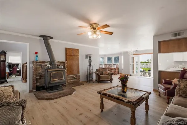 a view of an entryway wooden floor and a hallway