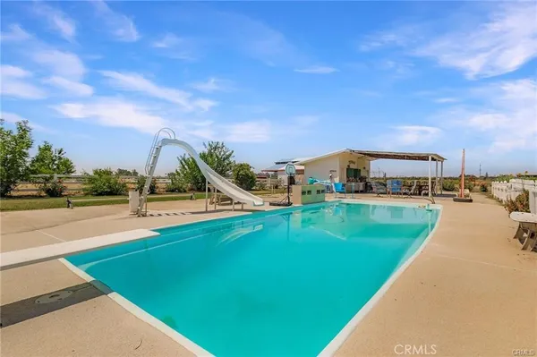 a view of a house with swimming pool and deck