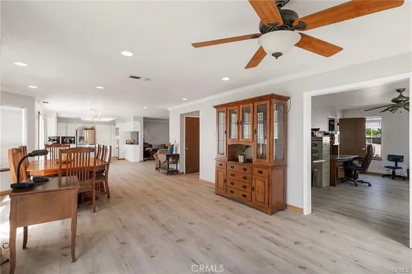 a dining room with furniture and wooden floor