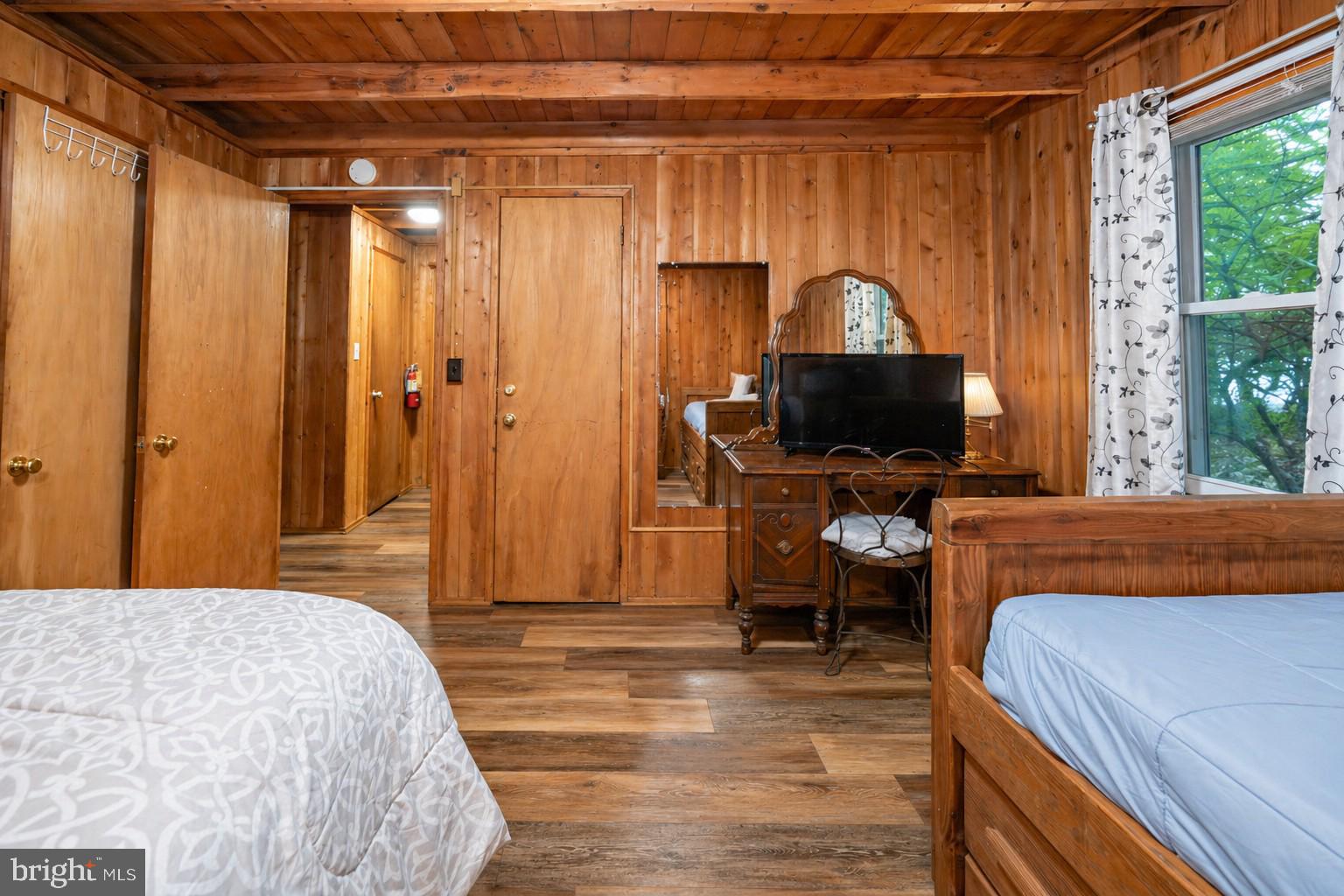 2187 State Park Road Swanton, MD 21561 - Photo 16 of 29 a bedroom with a bed and a chandelier
