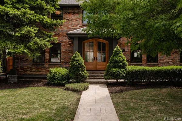 a front view of a house with a garden