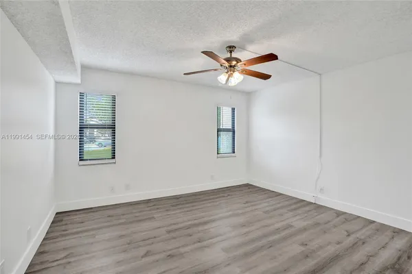 a view of room with hardwood floor and window