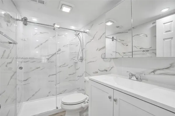 a bathroom with a sink toilet and shower