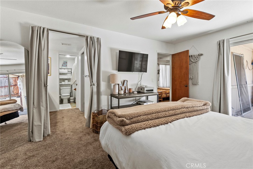 282 Robles Road, Unit 19 Arroyo Grande, CA 93420 - Photo 12 of 24 a bedroom with a large bed and a flat screen tv