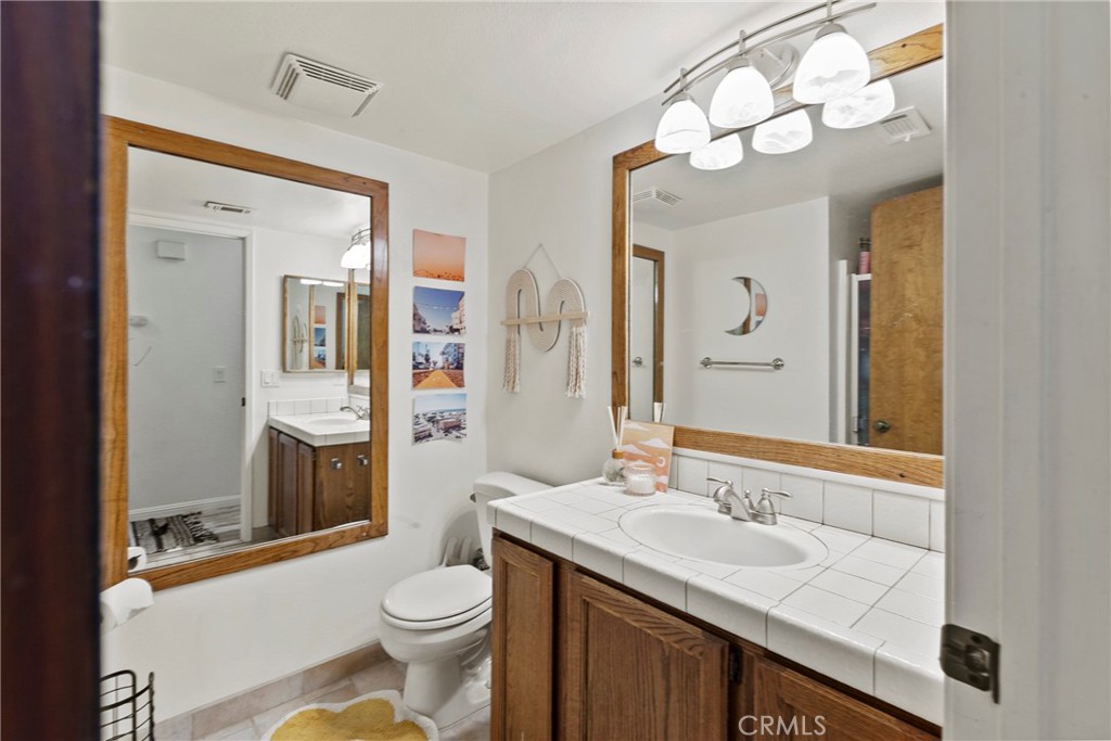 282 Robles Road, Unit 19 Arroyo Grande, CA 93420 - Photo 15 of 24 a bathroom with a sink a toilet and shower a mirror