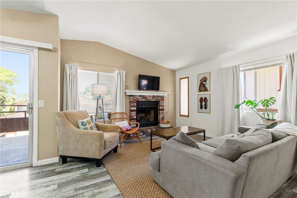 282 Robles Road, Unit 19 Arroyo Grande, CA 93420 - Photo 4 of 24 a living room with furniture a fireplace and a flat screen tv