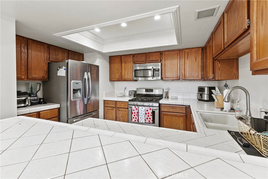 282 Robles Road, Unit 19 Arroyo Grande, CA 93420 - Photo 7 of 24 a kitchen with stainless steel appliances granite countertop a refrigerator and a sink