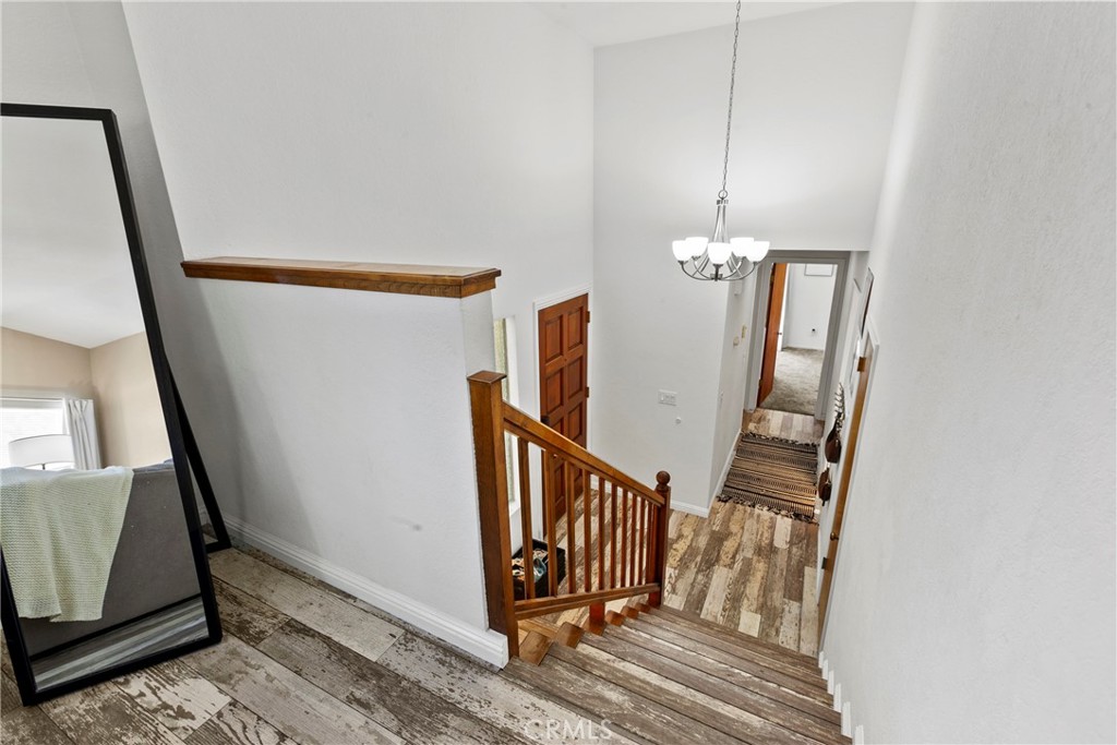 282 Robles Road, Unit 19 Arroyo Grande, CA 93420 - Photo 8 of 24 a view of a hallway with wooden floor and staircase