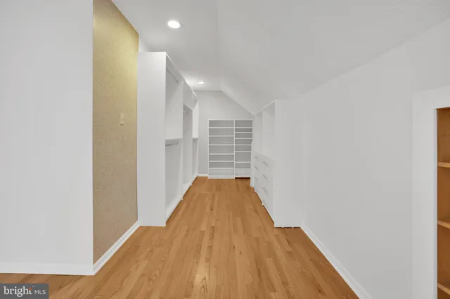 a view of a room with wooden floor and entryway