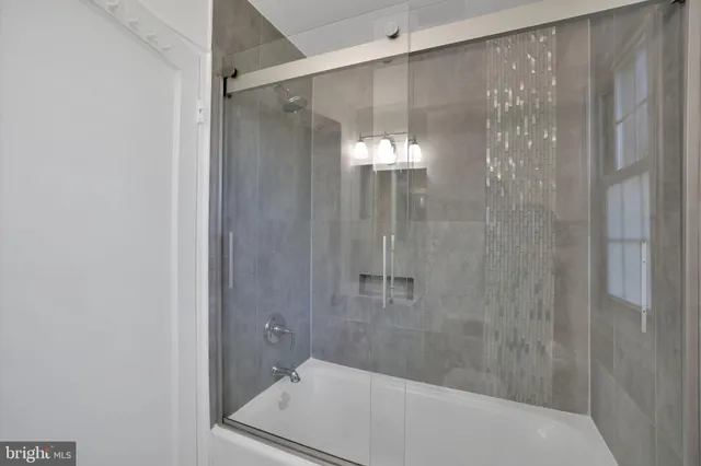 a bathroom with a shower and a sink