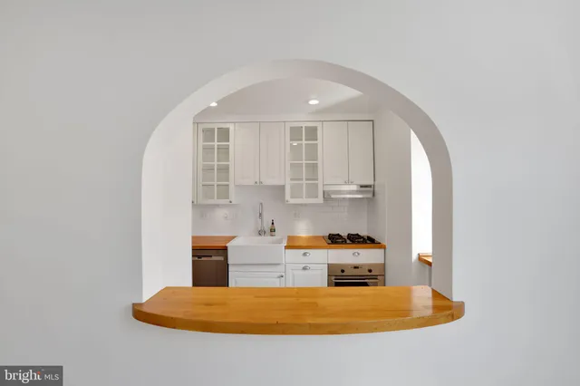 a kitchen with a refrigerator a stove a sink and a window