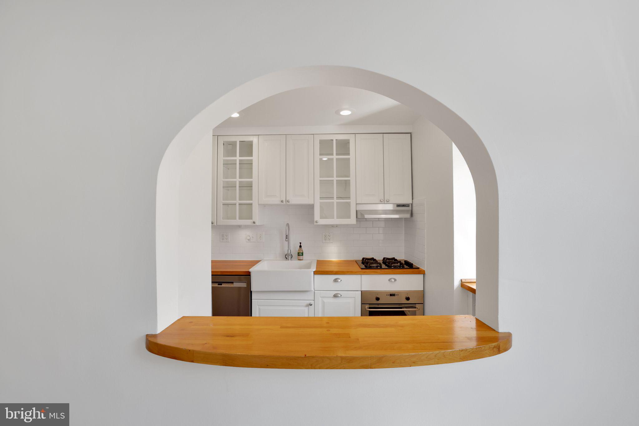 2312 Colston Drive, Unit 201 Silver Spring, MD 20910 - Photo 5 of 29 a kitchen with a refrigerator a stove a sink and a window