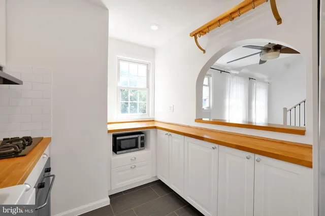 a view of a kitchen with a sink and a window