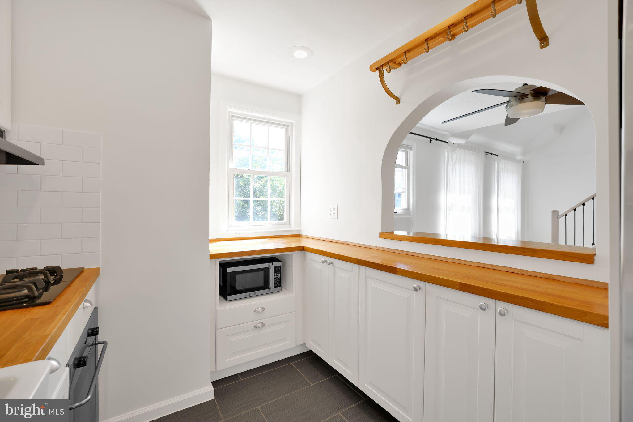 2312 Colston Drive, Unit 201 Silver Spring, MD 20910 - Photo 6 of 29 a view of a kitchen with a sink and a window