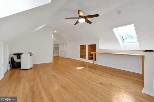 a bedroom with a bed and a ceiling fan