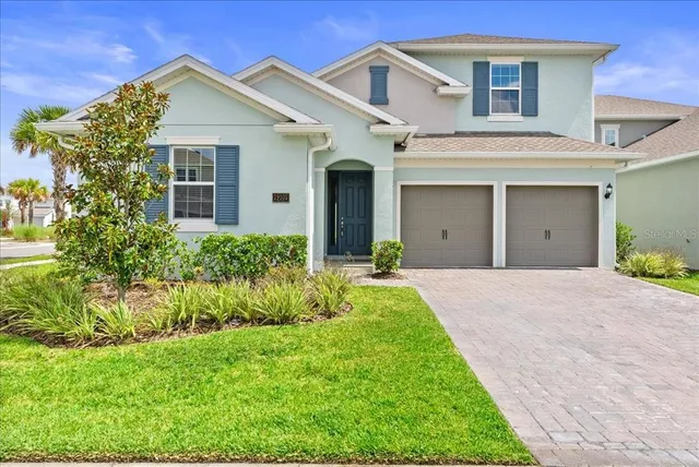 a front view of a house with a yard and garage