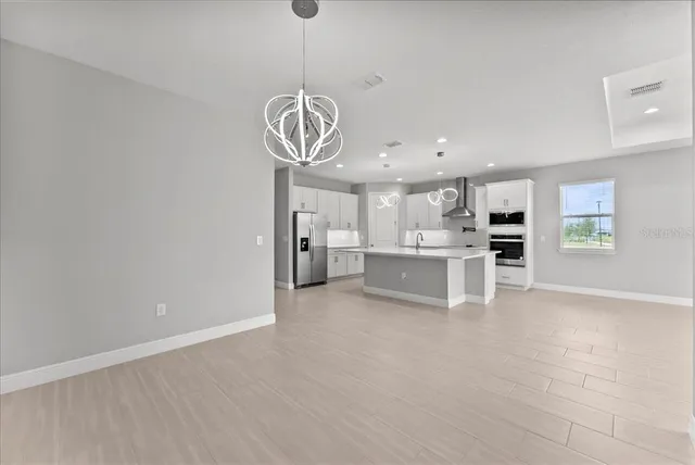 a view of a kitchen with a sink stainless steel appliances and cabinets