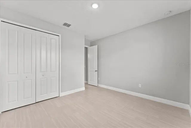 a view of an empty room and closet area