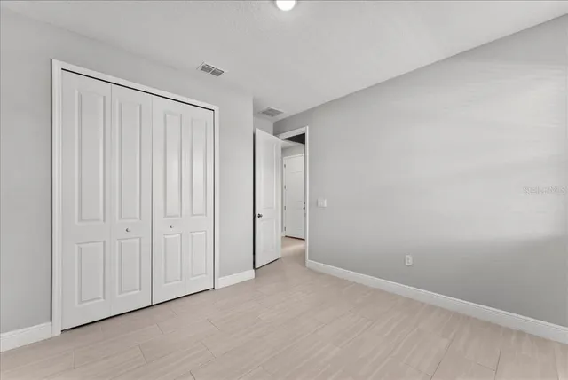 a view of an empty room and wooden floor