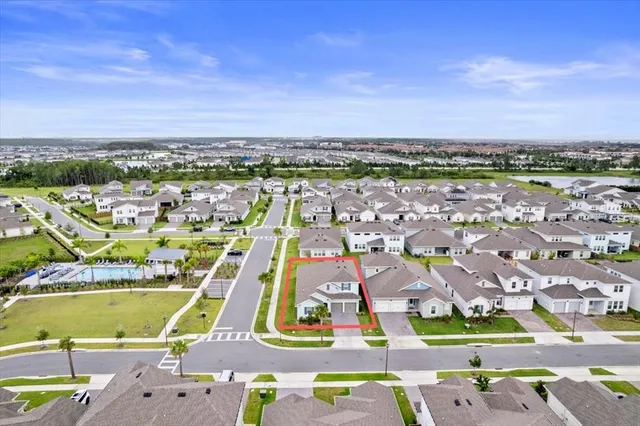 an aerial view of residential houses with outdoor space and swimming pool