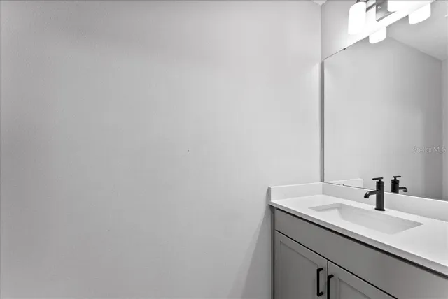 a bathroom with a sink and vanity