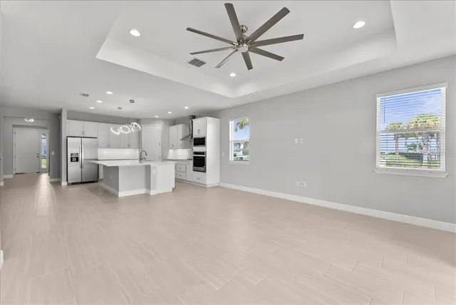 a view of a kitchen with a sink and a refrigerator