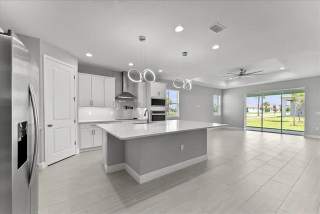 a large kitchen with kitchen island a sink stainless steel appliances and cabinets