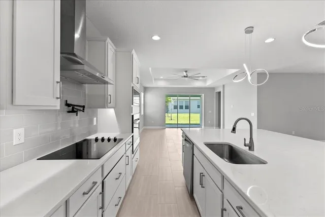 a kitchen with counter top space a sink stainless steel appliances and cabinets