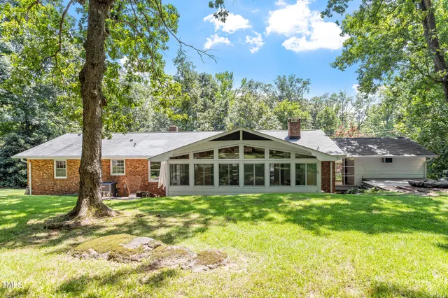 a front view of a house with sitting area