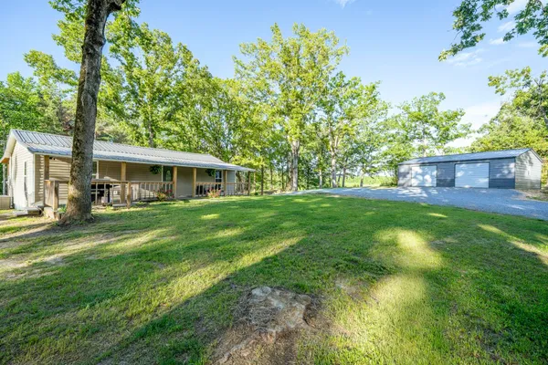 a front view of house with yard and green space