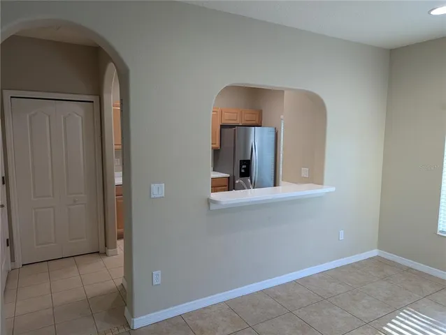 a kitchen with a refrigerator and a stove top oven