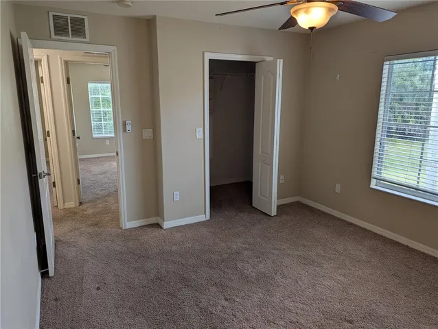 a bathroom with a granite countertop shower and a toilet