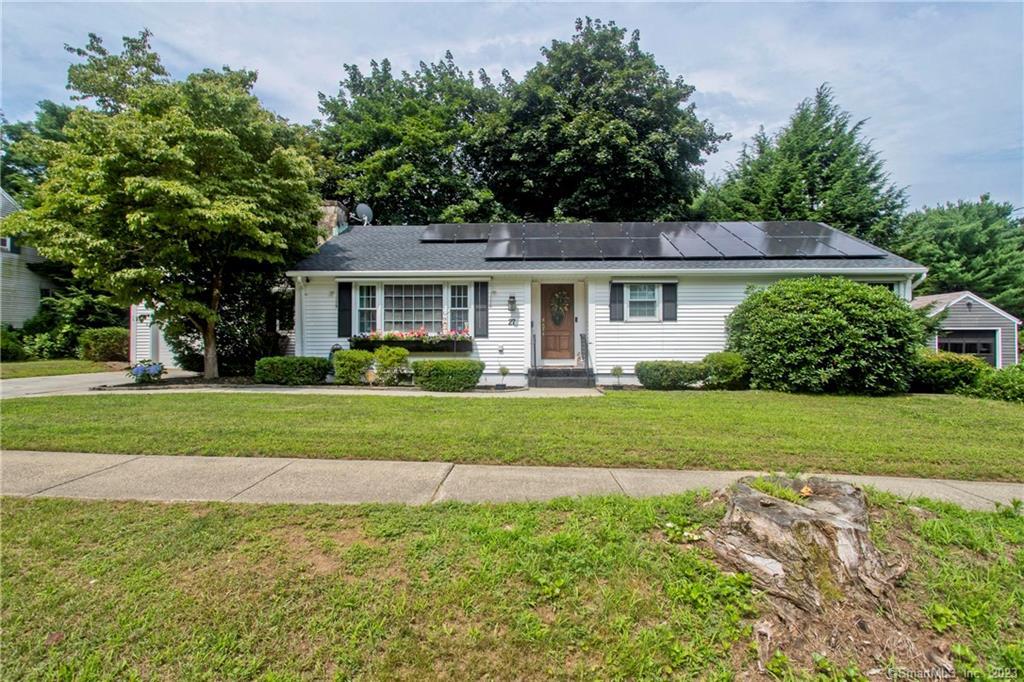 a front view of house with yard and green space