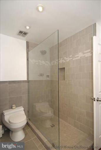 2137 Golf Course Drive Reston, VA 20191 - Photo 20 of 26 a bathroom with a shower and a toilet