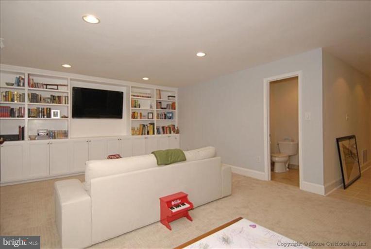 2137 Golf Course Drive Reston, VA 20191 - Photo 22 of 26 a living room with furniture and a flat screen tv