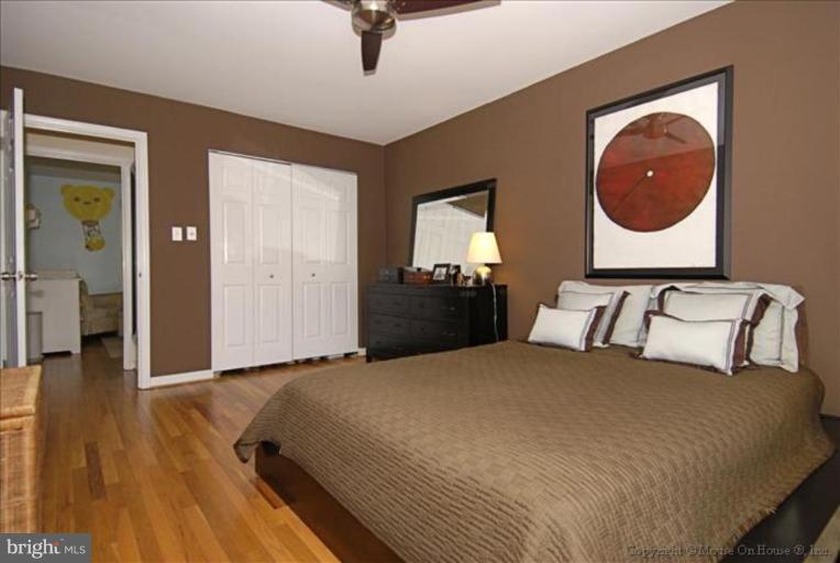 2137 Golf Course Drive Reston, VA 20191 - Photo 24 of 26 a bedroom with a bed and a painting on the wall