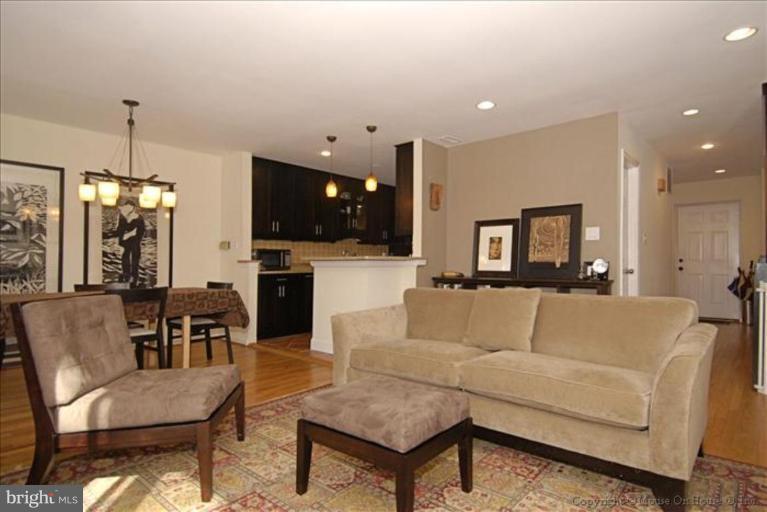 2137 Golf Course Drive Reston, VA 20191 - Photo 7 of 26 a living room with furniture kitchen view and a wooden floor