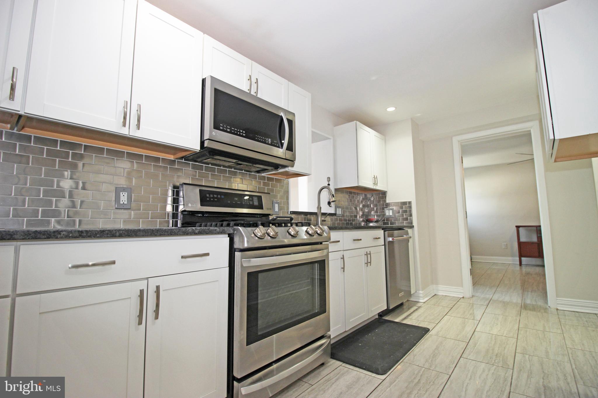 2748 Springhill Road Secane, PA 19018 - Photo 14 of 90 a kitchen with stainless steel appliances granite countertop a stove a sink and a microwave