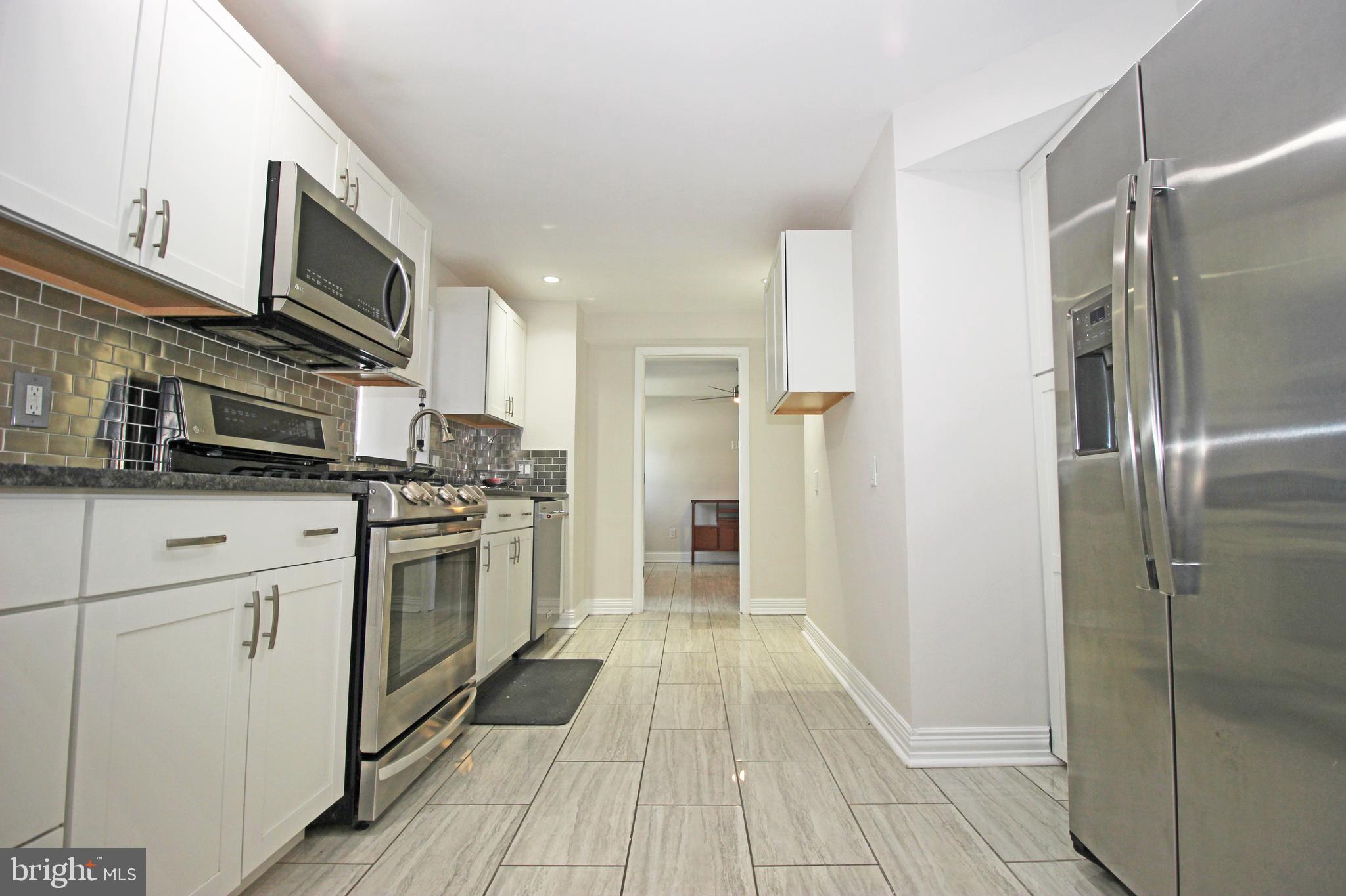 2748 Springhill Road Secane, PA 19018 - Photo 19 of 90 a kitchen with stainless steel appliances a refrigerator sink and microwave