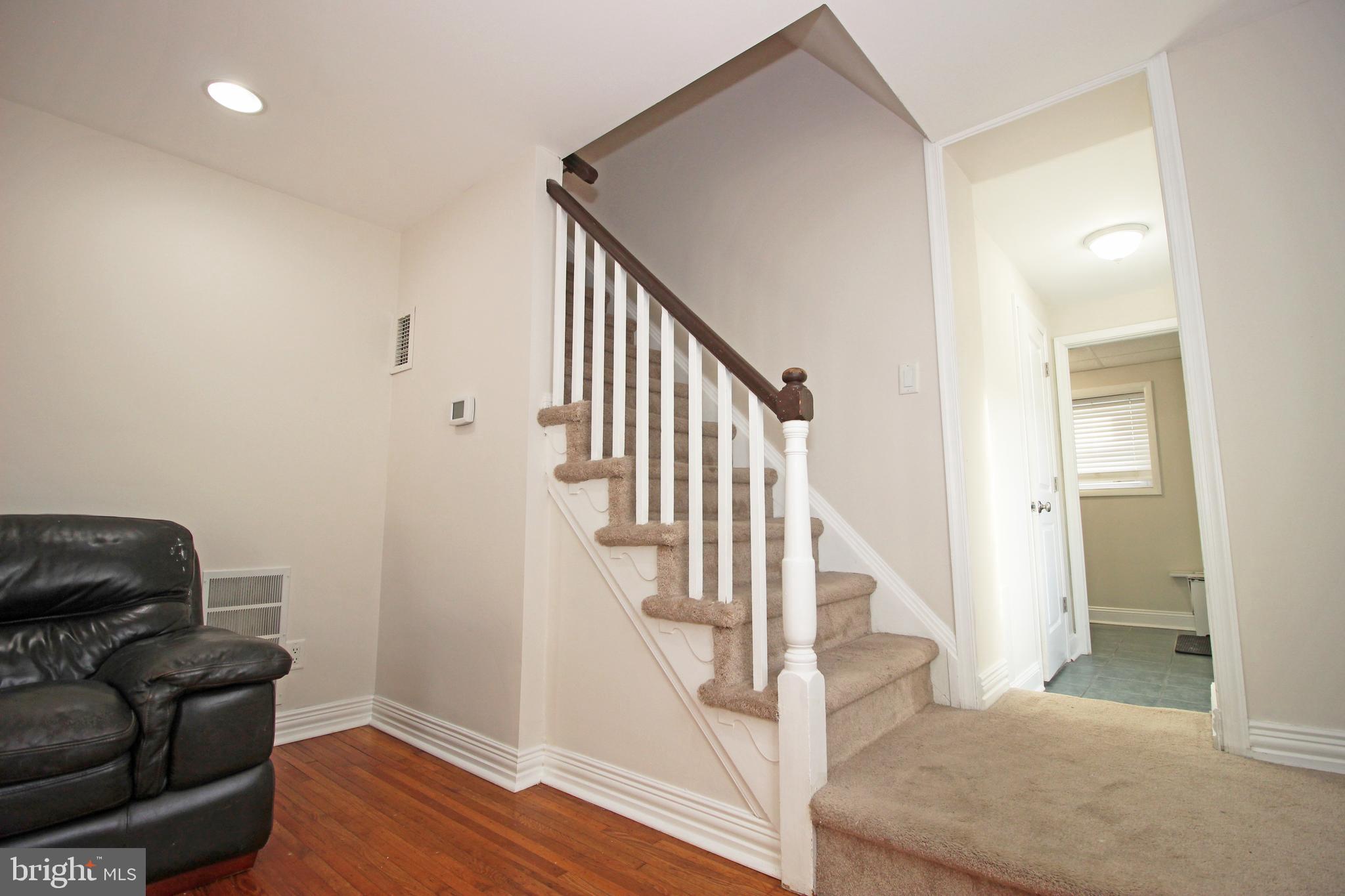 2748 Springhill Road Secane, PA 19018 - Photo 35 of 90 a view of a hallway with wooden floor and stairs