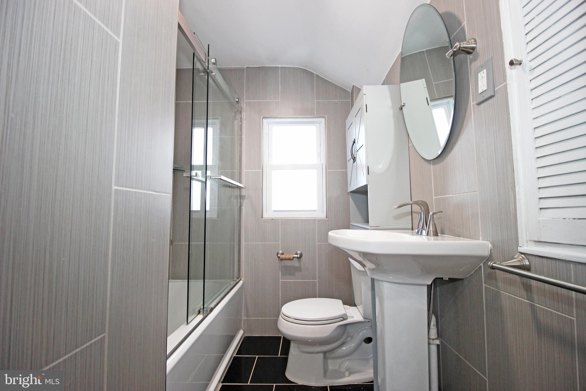2748 Springhill Road Secane, PA 19018 - Photo 47 of 90 a bathroom with a sink toilet and a mirror
