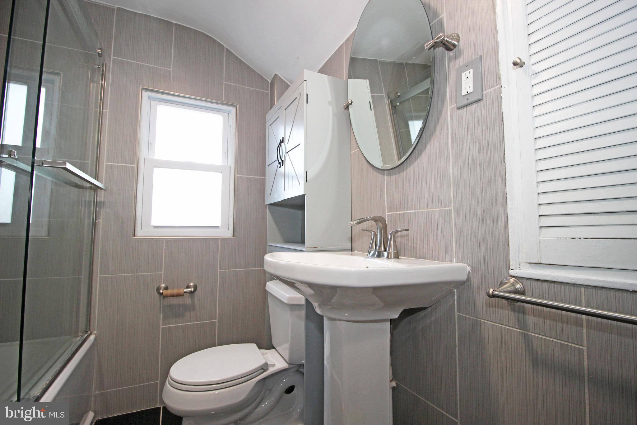 2748 Springhill Road Secane, PA 19018 - Photo 48 of 90 a bathroom with a toilet a sink and a mirror