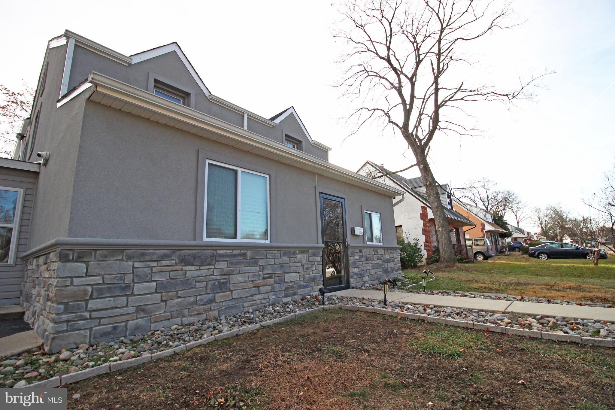 2748 Springhill Road Secane, PA 19018 - Photo 84 of 90 a brick house with a large tree in front of it