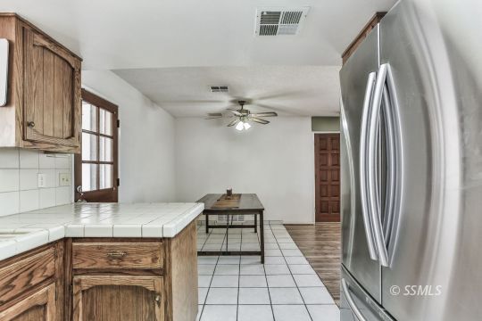 604 South Lakeview Court Ridgecrest, CA 93555 - Photo 12 of 29 a kitchen with stainless steel appliances granite countertop a refrigerator and a stove top oven
