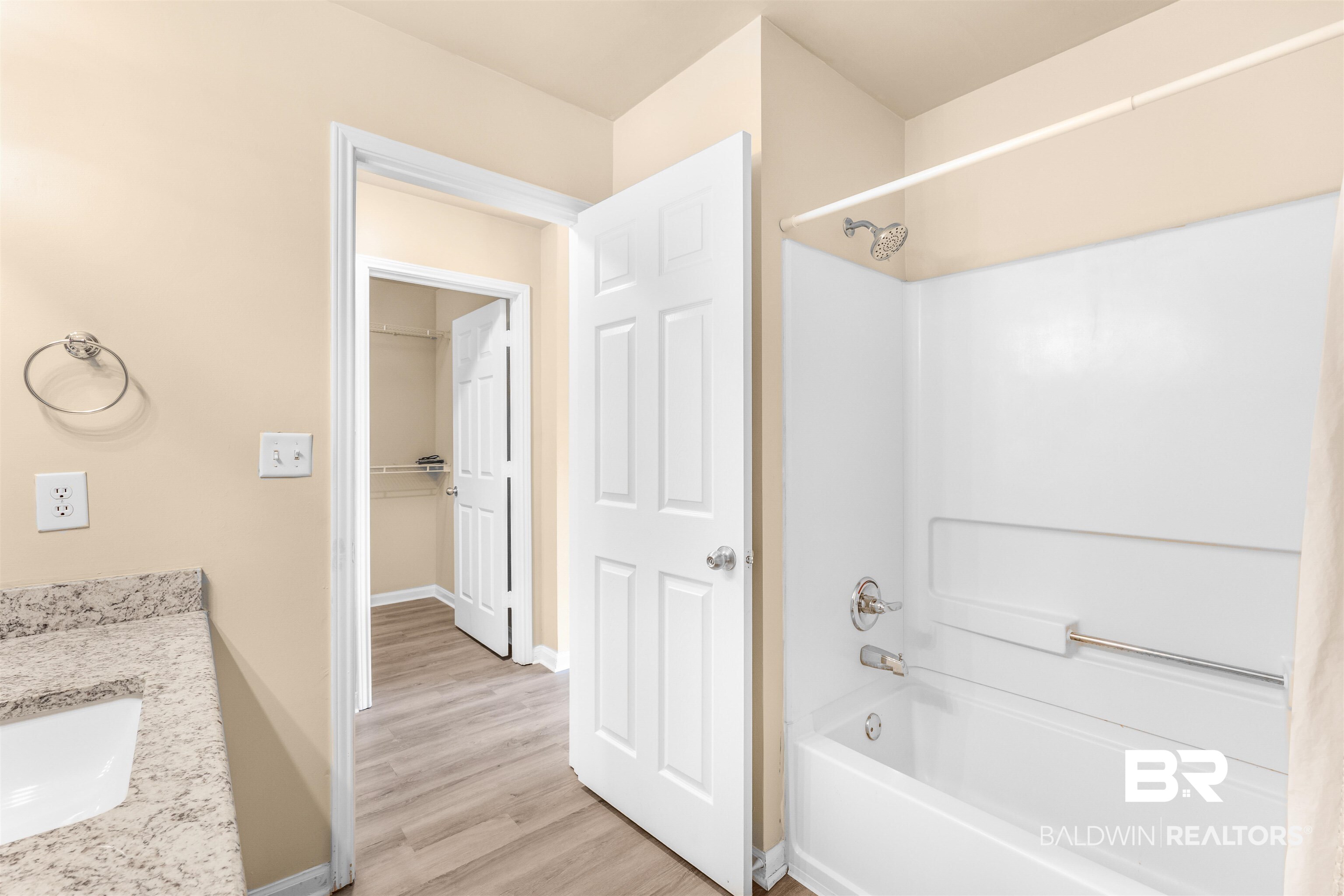 1517 Regency Road, Unit 85 Gulf Shores, AL 36542 - Photo 16 of 32 Bathroom featuring hardwood / wood-style flooring, washtub / shower combination, and vanity