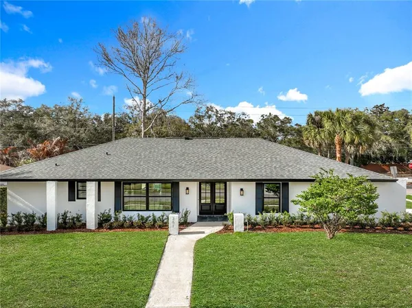 a front view of a house with a yard and porch