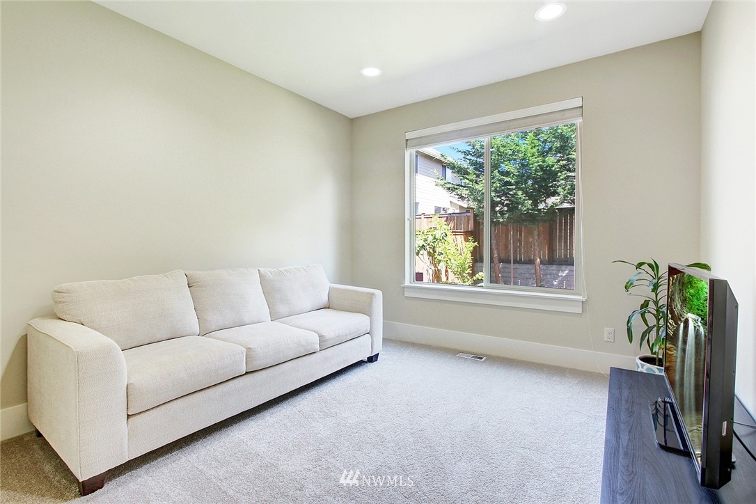 1119 South 47th Place Renton, WA 98055 - Photo 14 of 27 a living room with furniture and a large window