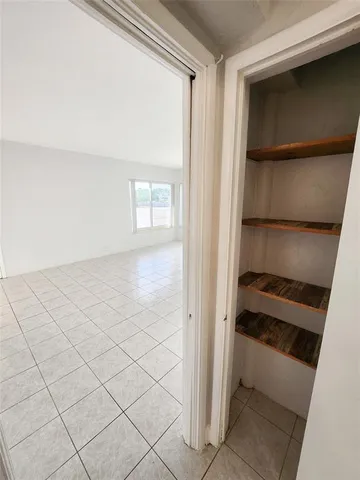 a view of an empty room and a window